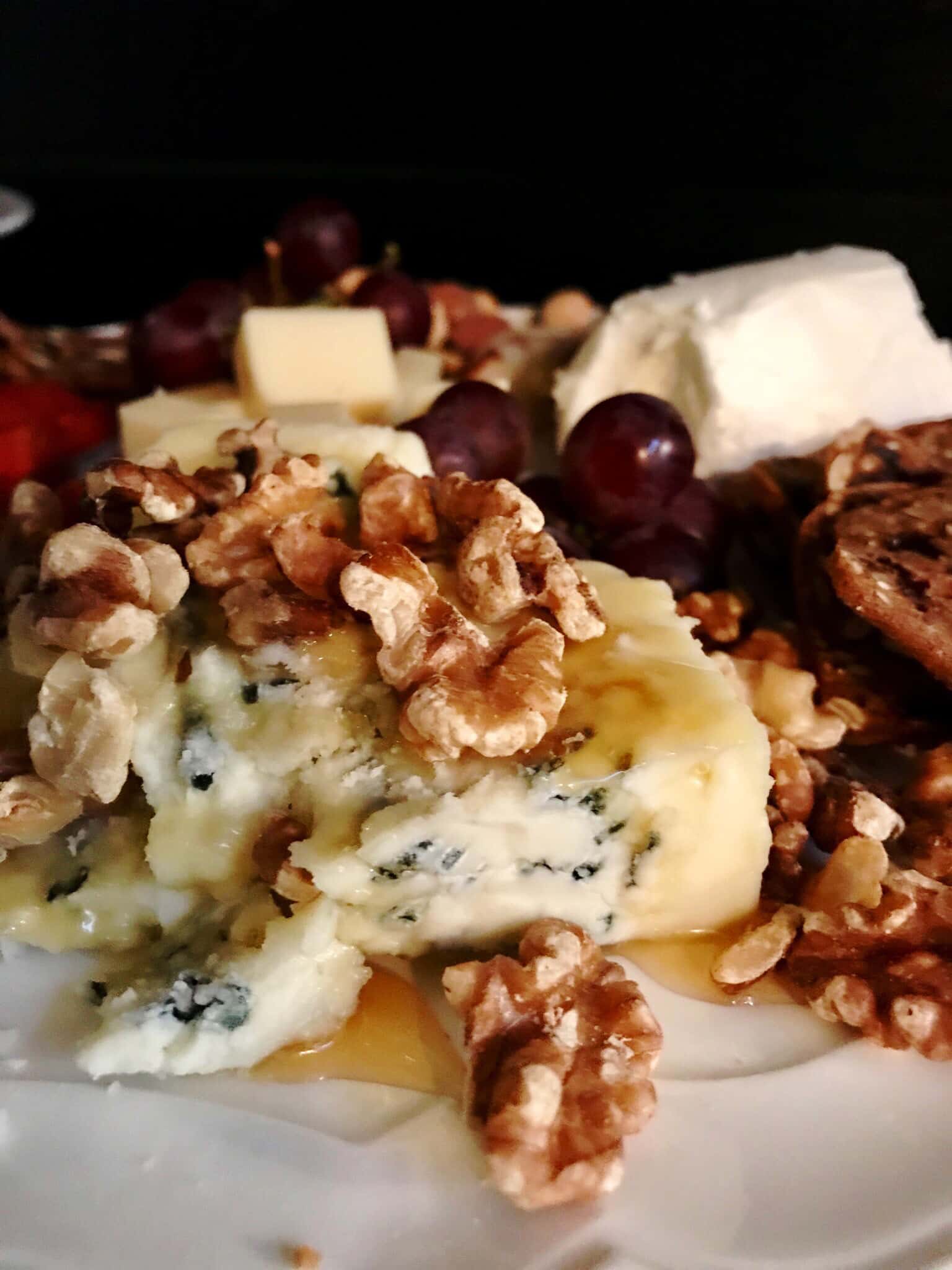 An elegantly simple cheese plate with blue cheese, honey, and walnuts.
